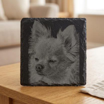 Fluffy dog portrait slate coaster on an oak table