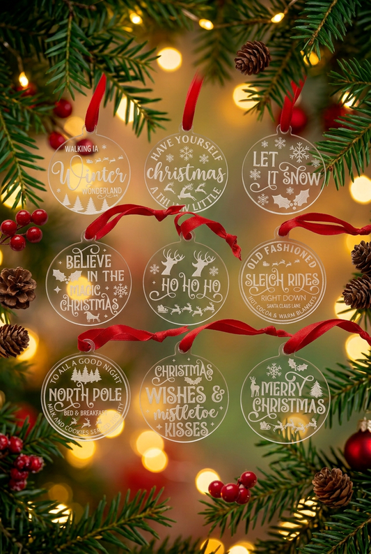 Glass Christmas decoration collection with evergreen branches and golden lights