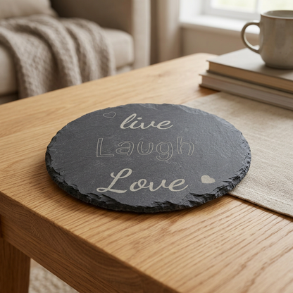 Live Laugh Love slate coaster on an oak table
