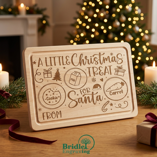 Engraved wooden Santa treat tray in a cosy Christmas Eve setting with golden fairy lights and Bridle Engraving logo