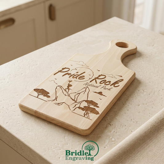 Pride Rock engraved wooden paddle board on a warm neutral kitchen background with a small Bridle Engraving logo