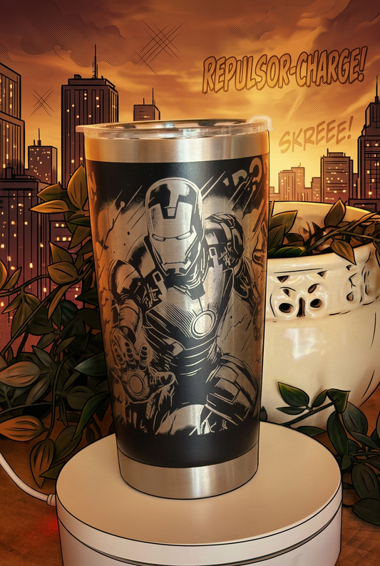 Black 500ml thermal coffee cup with silver-toned engraved Iron Man comic artwork, on a comic-book city background